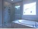 Beautiful bathroom featuring a separate shower, soaking tub, and natural light from a window at 200 Ironwood Lot 39 Blvd, Youngsville, NC 27596
