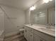Modern bathroom featuring double sinks, a quartz countertop, and a tile backsplash with updated fixtures at 200 Ironwood Lot 39 Blvd, Youngsville, NC 27596