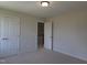 Clean bedroom with neutral walls and double closet at 200 Ironwood Lot 39 Blvd, Youngsville, NC 27596