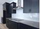 Close-up of the gourmet kitchen with stainless steel hood and dark cabinetry at 200 Ironwood Lot 39 Blvd, Youngsville, NC 27596
