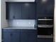 Modern kitchen featuring stainless steel appliances, granite countertops, and dark cabinetry at 200 Ironwood Lot 39 Blvd, Youngsville, NC 27596