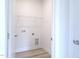 Functional laundry room with modern hookups and shelf for storage at 200 Ironwood Lot 39 Blvd, Youngsville, NC 27596