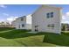 View of backyard with lush green lawn and partial view of the home's exterior at 262 Moore Creek Dr, Fuquay Varina, NC 27526
