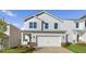 Beautiful two-story home featuring a two car garage, architectural shingles, and professionally designed landscape at 262 Moore Creek Dr, Fuquay Varina, NC 27526