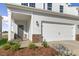 Two-story home featuring a two-car garage, covered entry and professionally landscaped front yard at 262 Moore Creek Dr, Fuquay Varina, NC 27526