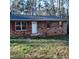 Brick ranch house with red shutters, and a small front porch at 2800 Coleman Loop Rd, Hillsborough, NC 27278