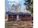Brick ranch house with red shutters, and a small front porch at 2800 Coleman Loop Rd, Hillsborough, NC 27278