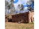 Exterior shot of the back of the house, which is brick and contains a grill at 2800 Coleman Loop Rd, Hillsborough, NC 27278