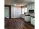 Kitchen with white cabinets, dark countertops, and laminate flooring at 2800 Coleman Loop Rd, Hillsborough, NC 27278