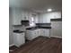 Kitchen with white cabinets, dark countertops, and laminate flooring at 2800 Coleman Loop Rd, Hillsborough, NC 27278