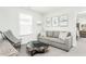 Cozy sitting room features a comfy sofa, armchair, and coffee table at 418 Providence Springs Ln, Fuquay Varina, NC 27526