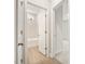 Hallway view of bathroom with tiled shower and flooring, and modern fixtures at 906 Brookfield Dr, Gibsonville, NC 27249