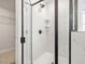 Modern bathroom features a walk-in shower with sleek black trim and tiled walls at 906 Brookfield Dr, Gibsonville, NC 27249