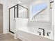 Bathroom featuring a soaking tub and separate glass enclosed shower with white marble tile at 906 Brookfield Dr, Gibsonville, NC 27249