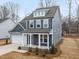 Corner lot house boasts a two-car garage, covered porch, and beautifully maintained landscaping at 906 Brookfield Dr, Gibsonville, NC 27249