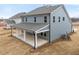 Two-story home with a large covered patio and gray siding at 906 Brookfield Dr, Gibsonville, NC 27249