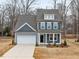 Charming two-story home with a two-car garage, covered front porch, and professionally landscaped front yard at 906 Brookfield Dr, Gibsonville, NC 27249
