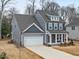 A view of a two-story house from above the house highlighting the driveway, covered porch, and garage at 906 Brookfield Dr, Gibsonville, NC 27249
