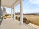 The front porch is covered with elegant white pillars, views of the surrounding landscape and a concrete floor at 906 Brookfield Dr, Gibsonville, NC 27249