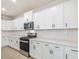 Bright kitchen features white cabinets, stainless steel appliances, and quartz countertops at 906 Brookfield Dr, Gibsonville, NC 27249