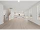 Open floor plan living room flowing into kitchen with island and modern lighting at 906 Brookfield Dr, Gibsonville, NC 27249