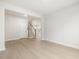 Open-concept living room with wood floors and view of staircase and kitchen at 906 Brookfield Dr, Gibsonville, NC 27249