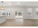 Living room with multiple windows, sliding door, and view of the backyard at 906 Brookfield Dr, Gibsonville, NC 27249
