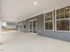 Covered back patio with gray siding, white trim, and sliding door at 906 Brookfield Dr, Gibsonville, NC 27249