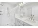 Modern bathroom with double sinks, glass enclosed shower with a bench, and bright lighting at 11548 Helmond Way # 118, Raleigh, NC 27617