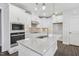 Modern kitchen featuring white cabinets, stainless steel appliances, and a marble countertop island at 11548 Helmond Way # 118, Raleigh, NC 27617