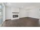 Bright living room with a modern fireplace, stylish chandelier, and sliding glass doors at 11548 Helmond Way # 118, Raleigh, NC 27617