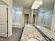 Double vanity with granite countertop, framed mirrors, and bright lighting at 166 Vega Loop, Sanford, NC 27330