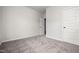 Carpeted bedroom featuring an open door and a white door leading to closet or bathroom at 166 Vega Loop, Sanford, NC 27330