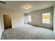 Neutral bedroom featuring large windows, an ensuite, and plush carpet at 166 Vega Loop, Sanford, NC 27330