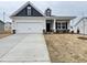 Charming single-Gathering home with a two-car garage and inviting covered front porch at 166 Vega Loop, Sanford, NC 27330