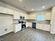 Modern kitchen with white cabinetry, granite countertops, and stainless steel appliances at 166 Vega Loop, Sanford, NC 27330