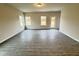 Bright and airy living area with wood-look floors and plenty of natural light through windows at 166 Vega Loop, Sanford, NC 27330