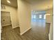 Open-concept living space with wood-look floors and ample natural light from numerous windows at 166 Vega Loop, Sanford, NC 27330