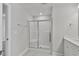 Modern bathroom with walk-in shower and neutral tile flooring and a single vanity at 527 Eversden Dr, Zebulon, NC 27597