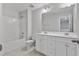 Bright bathroom with dual vanity, large mirror, and a shower-tub combination at 527 Eversden Dr, Zebulon, NC 27597