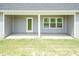 This back porch has concrete floors, a door, and a window at 596 Ravensworth Dr, Garner, NC 27529