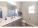 This bathroom has a framed mirror, a sink, a toilet, and a walk-in shower at 596 Ravensworth Dr, Garner, NC 27529