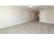 This bonus room features gray carpet, recessed lighting, and a door at 596 Ravensworth Dr, Garner, NC 27529
