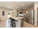 Kitchen boasts granite countertops, gray wood cabinets, a stainless steel refrigerator, and a kitchen island at 596 Ravensworth Dr, Garner, NC 27529