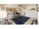 Spacious living room open to the kitchen, featuring hardwood floors, a fireplace, and modern furnishings at 596 Ravensworth Dr, Garner, NC 27529