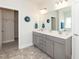 Bright bathroom with a double sink vanity, a large mirror, and a neutral color scheme at 596 Ravensworth Dr, Garner, NC 27529