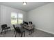 Home office with a modern desk, bright lighting, and neutral walls at 596 Ravensworth Dr, Garner, NC 27529