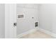 Utility room with tiled floors, shelving and connections for laundry appliances at 828 Putney Hill Rd, Zebulon, NC 27597