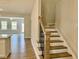 Elegant staircase with wood railings leading to the upper level at 828 Putney Hill Rd, Zebulon, NC 27597