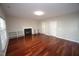 Living room with hardwood floors, fireplace, and built-in shelves at 104 Harvolly Dr, Holly Springs, NC 27540